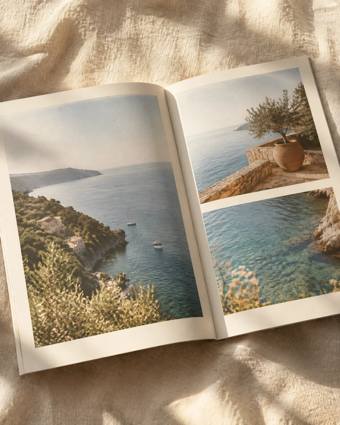 Open travel brochure with coastal photographs lying on linen in sunlight