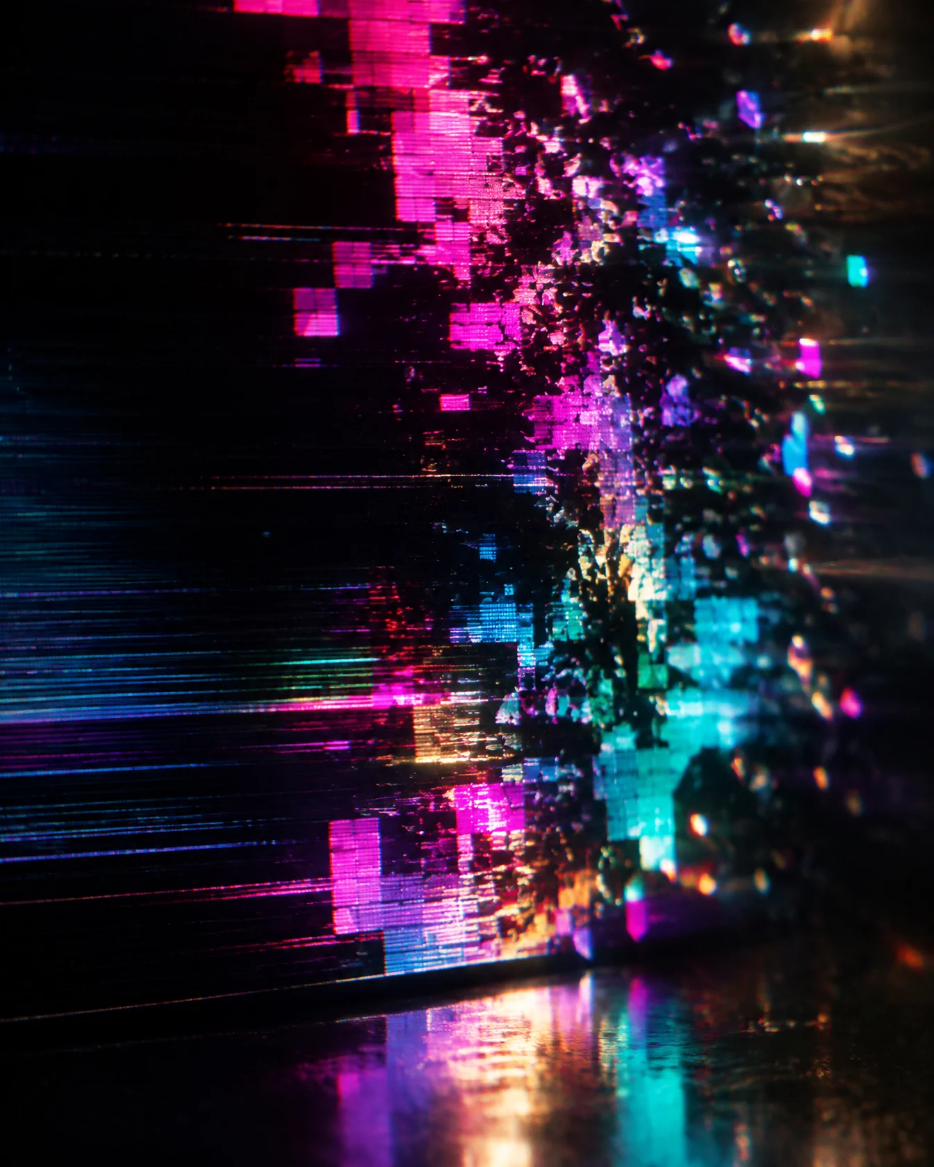 Neon pixel fragments in pink and teal glitching apart on a dark screen